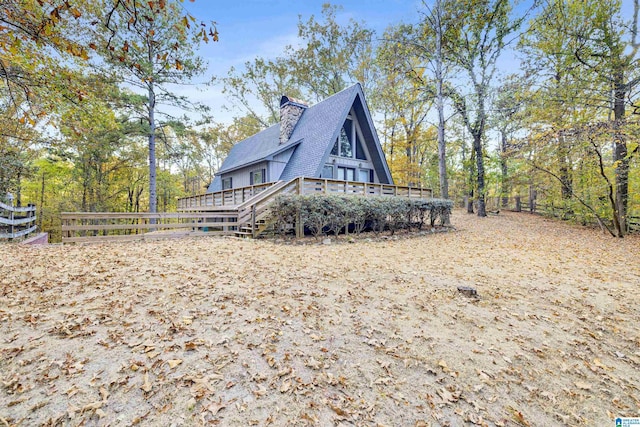 back of house with a wooden deck