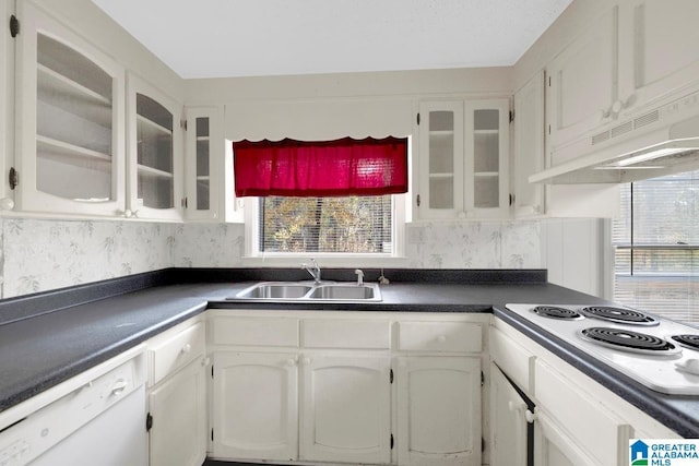 kitchen with white cabinetry, sink, backsplash, white appliances, and custom range hood