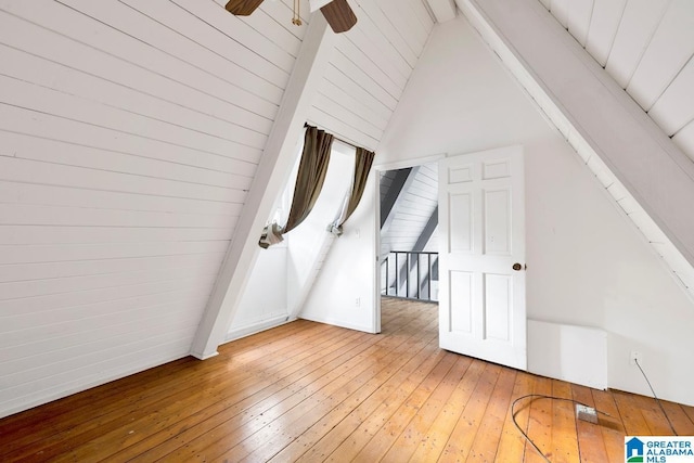 bonus room featuring beam ceiling, ceiling fan, high vaulted ceiling, and wood-type flooring