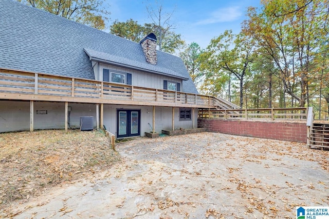 back of house with central AC, french doors, and a deck