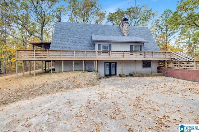 back of house featuring french doors, cooling unit, and a wooden deck