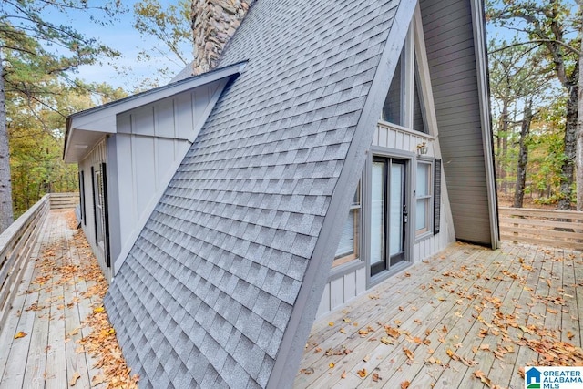 view of property exterior with a wooden deck