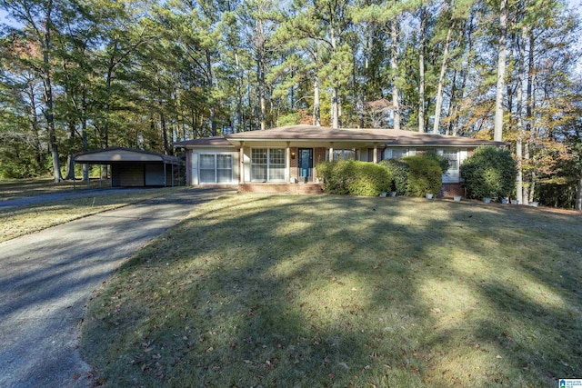 ranch-style home featuring a front yard and a carport