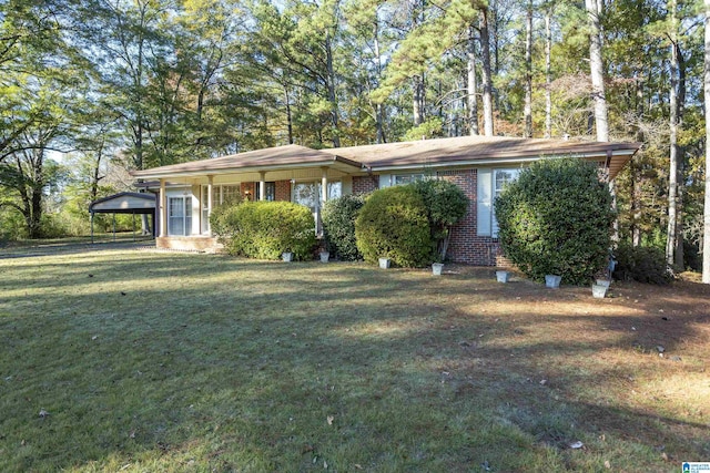 ranch-style house featuring a front lawn and a carport