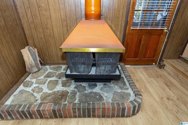 details with hardwood / wood-style flooring and wood walls