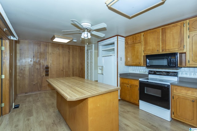 kitchen featuring ceiling fan, a center island, backsplash, light hardwood / wood-style floors, and white appliances