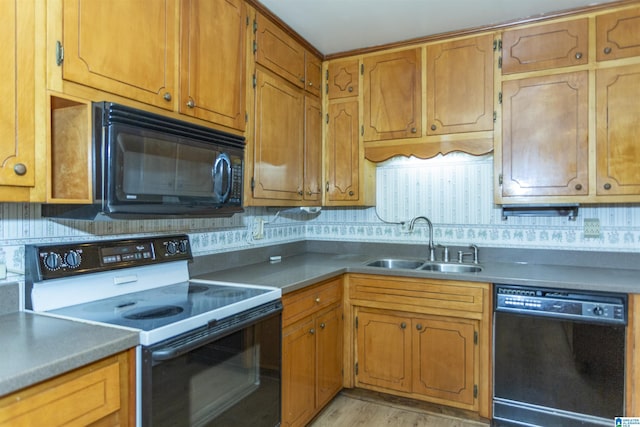 kitchen with sink, backsplash, light hardwood / wood-style floors, and black appliances