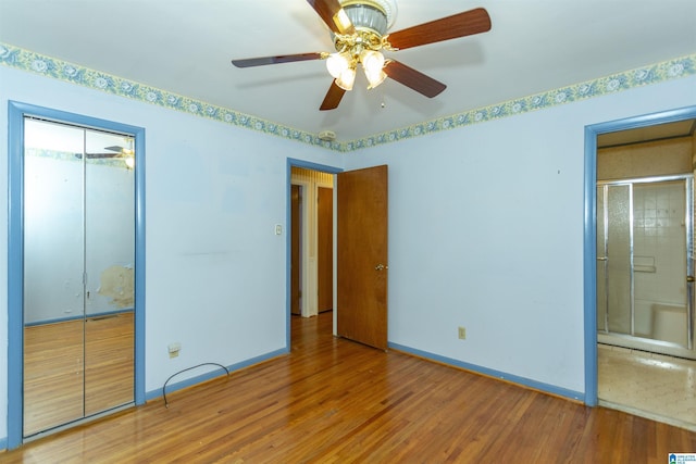 unfurnished bedroom with ceiling fan, a closet, and wood-type flooring