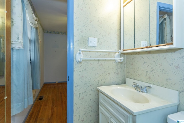 bathroom with vanity and hardwood / wood-style flooring