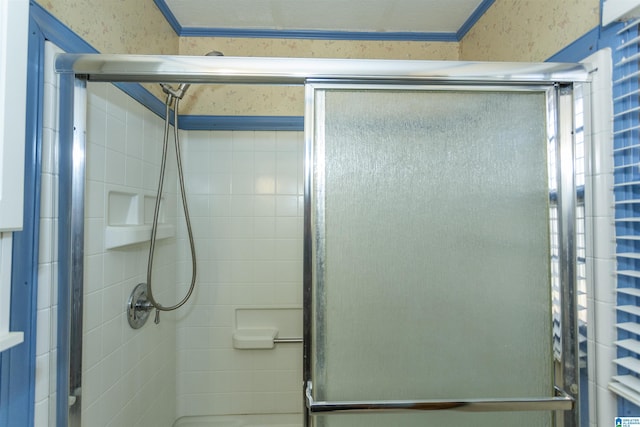 bathroom featuring walk in shower and ornamental molding