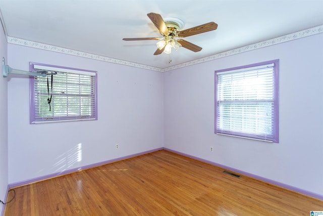 unfurnished room featuring hardwood / wood-style floors and ceiling fan