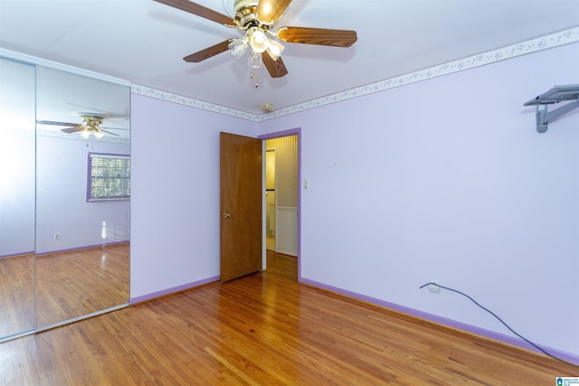 unfurnished bedroom with ceiling fan and hardwood / wood-style floors