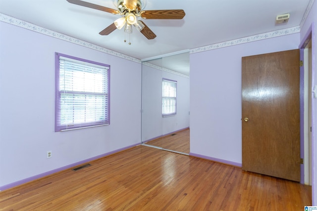 unfurnished bedroom featuring a closet, ceiling fan, and hardwood / wood-style flooring