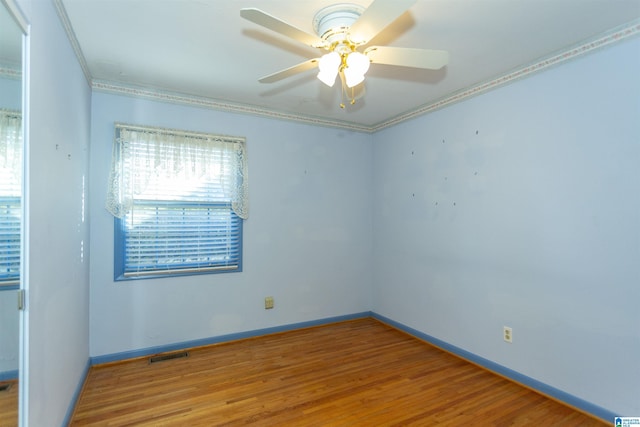 unfurnished room with crown molding, ceiling fan, and wood-type flooring