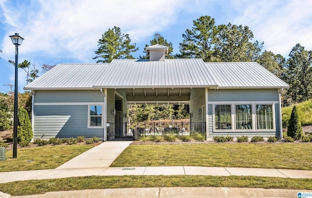 view of front of house with cooling unit, a front lawn, and a carport