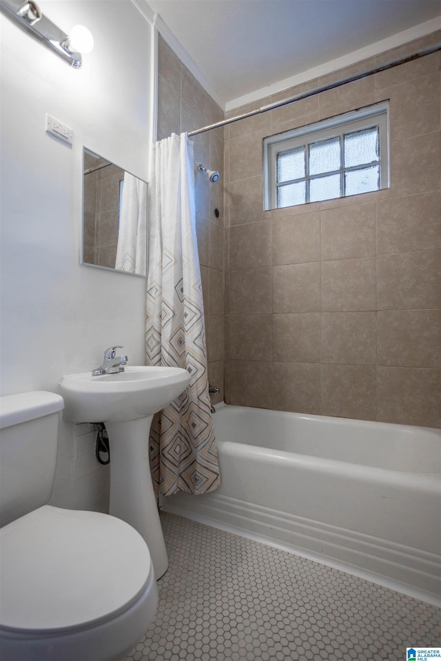 bathroom featuring tile patterned flooring, shower / bathtub combination with curtain, and toilet