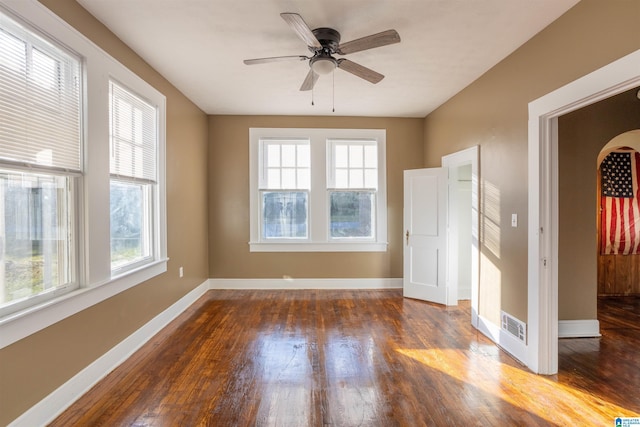 spare room with ceiling fan and dark wood-type flooring