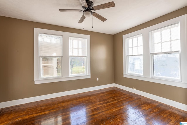 spare room featuring ceiling fan and dark hardwood / wood-style floors