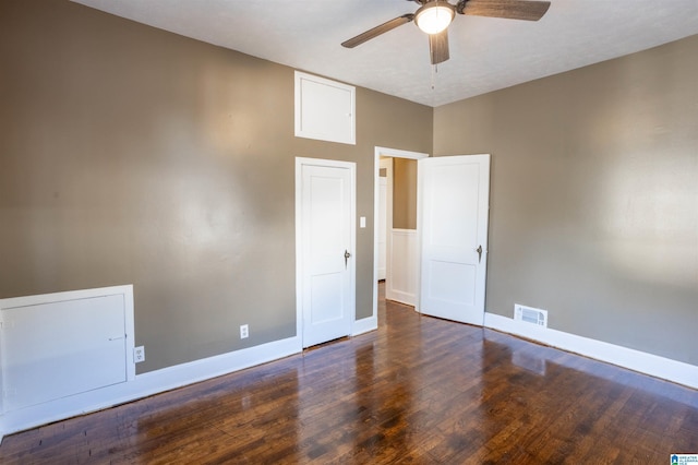 spare room featuring a textured ceiling, ceiling fan, and dark wood-type flooring