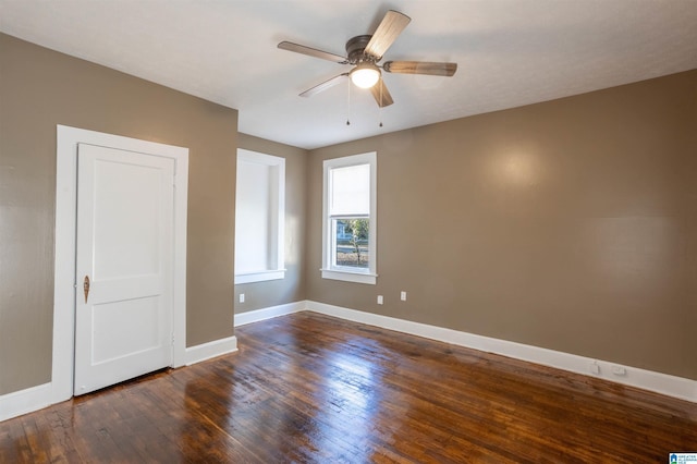 spare room with dark hardwood / wood-style floors and ceiling fan