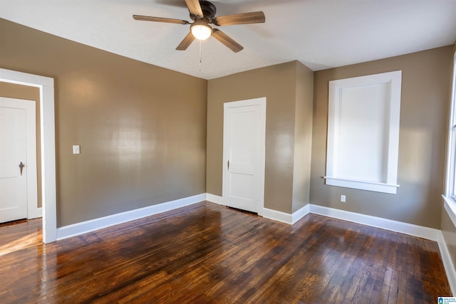 unfurnished bedroom featuring ceiling fan and dark wood-type flooring