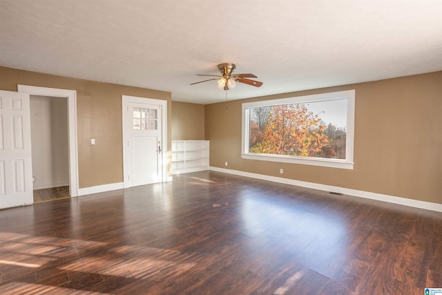 spare room with dark hardwood / wood-style floors and ceiling fan