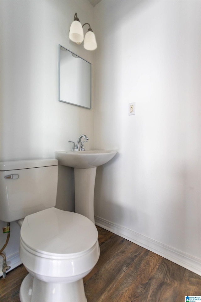 bathroom with hardwood / wood-style floors and toilet