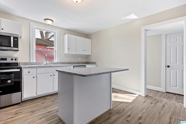 kitchen featuring white cabinetry, light hardwood / wood-style flooring, and stainless steel appliances