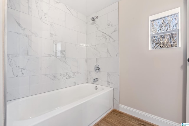 bathroom featuring hardwood / wood-style floors and tiled shower / bath