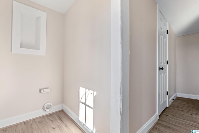 laundry area featuring electric dryer hookup and light hardwood / wood-style flooring