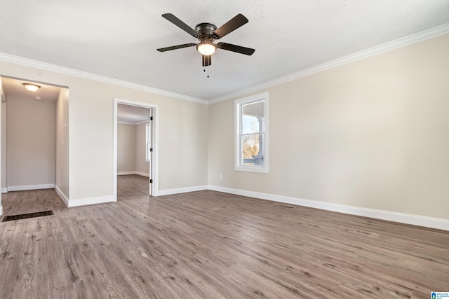 unfurnished bedroom featuring light hardwood / wood-style floors, ceiling fan, and ornamental molding