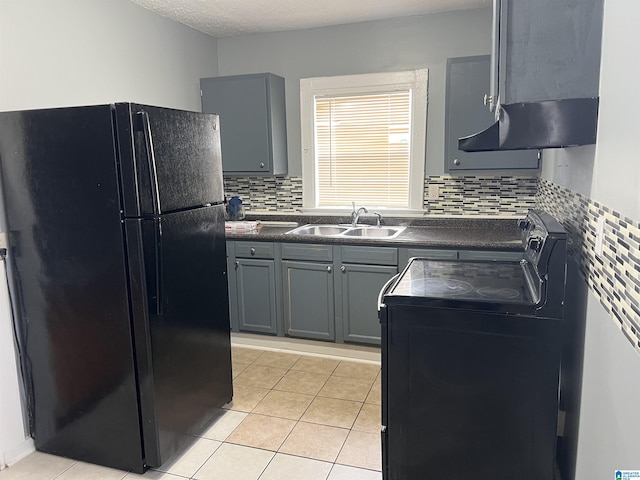 kitchen with gray cabinetry, sink, exhaust hood, backsplash, and black appliances