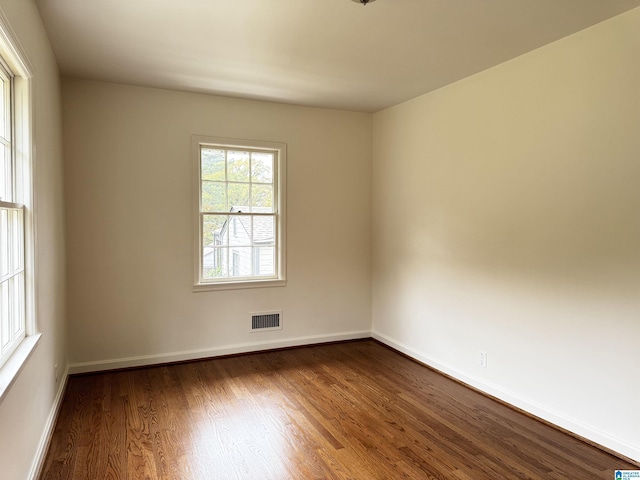 spare room with dark hardwood / wood-style floors