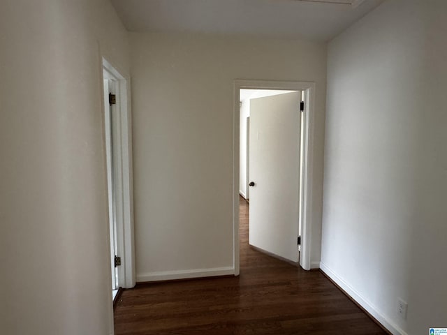 corridor with dark hardwood / wood-style floors