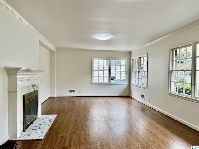 unfurnished living room featuring a fireplace, dark hardwood / wood-style flooring, and ornamental molding