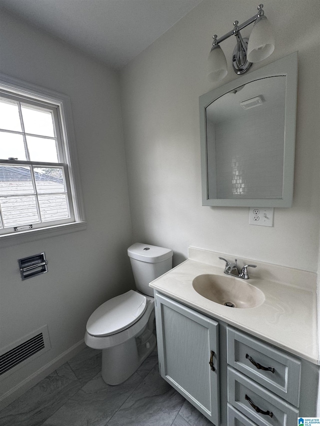 bathroom with vanity and toilet