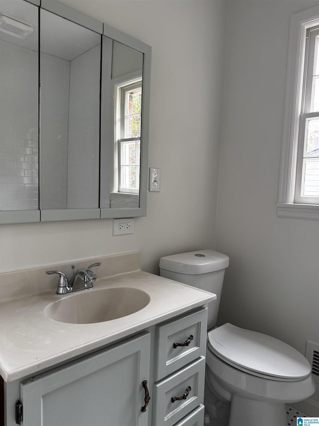 bathroom featuring vanity and toilet