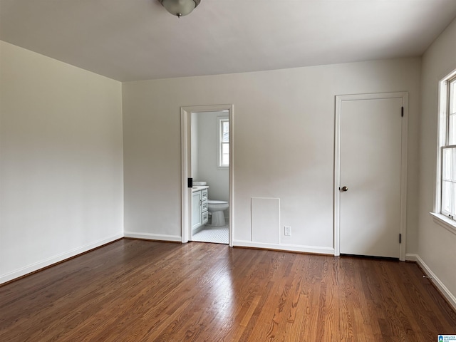 empty room with dark hardwood / wood-style flooring