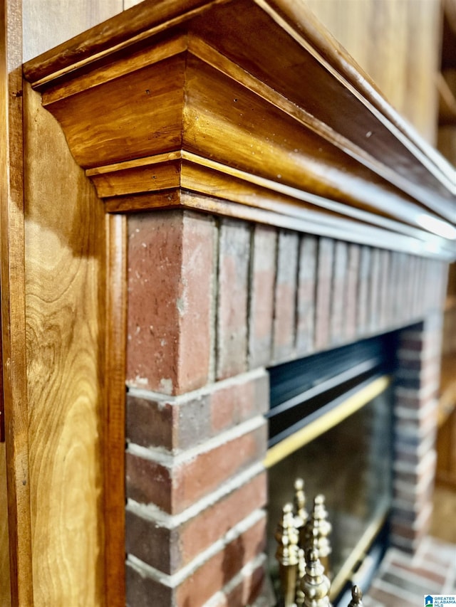 interior details featuring a brick fireplace