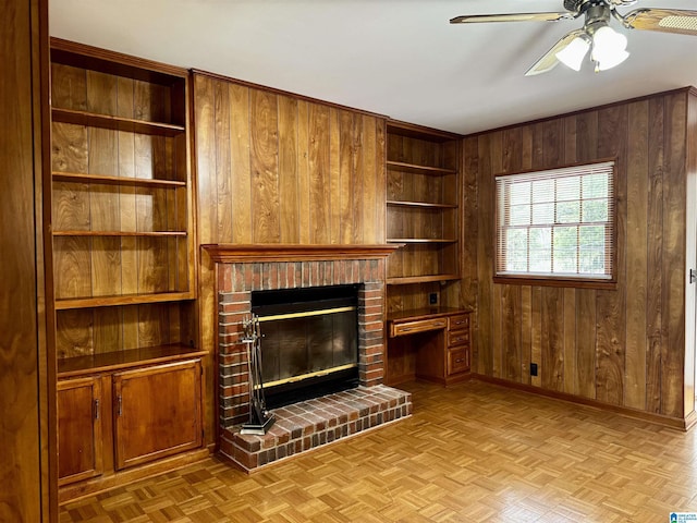 unfurnished living room featuring wood walls, light parquet flooring, and ceiling fan