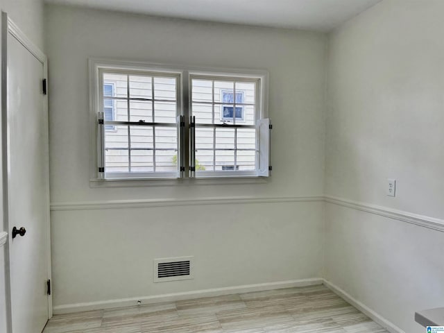 empty room with light hardwood / wood-style flooring