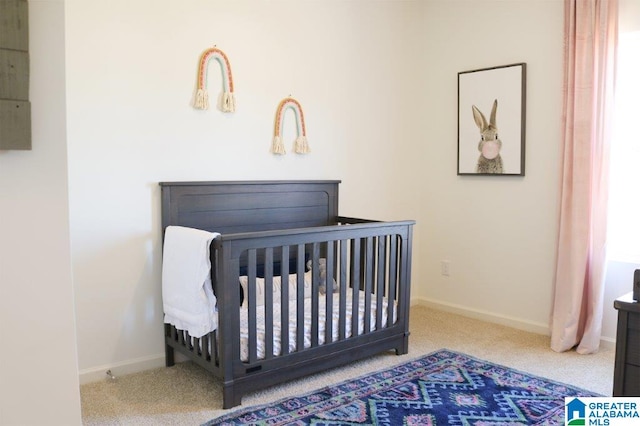 bedroom featuring carpet and a crib