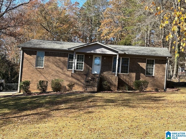 single story home with brick siding and a front yard