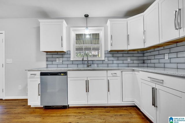 kitchen featuring white cabinets, light hardwood / wood-style floors, stainless steel dishwasher, and sink