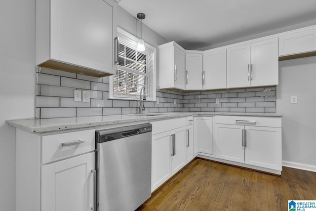 kitchen with hanging light fixtures, dark wood-type flooring, white cabinets, and stainless steel dishwasher