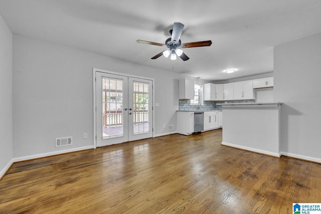 unfurnished living room with french doors, dark hardwood / wood-style flooring, and ceiling fan