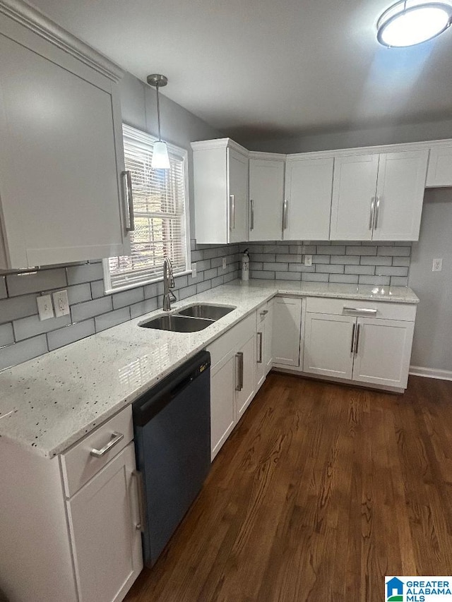 kitchen with sink, stainless steel dishwasher, dark hardwood / wood-style floors, decorative light fixtures, and white cabinetry