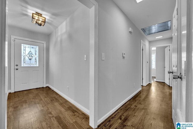 entrance foyer featuring dark hardwood / wood-style floors and a healthy amount of sunlight