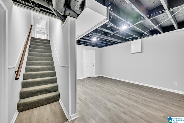 basement with hardwood / wood-style flooring