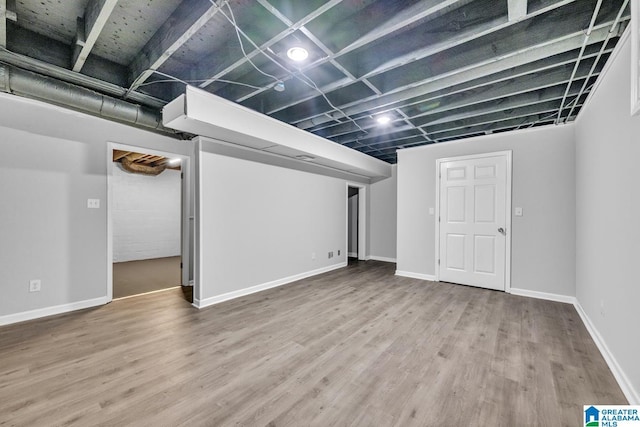 basement with hardwood / wood-style flooring